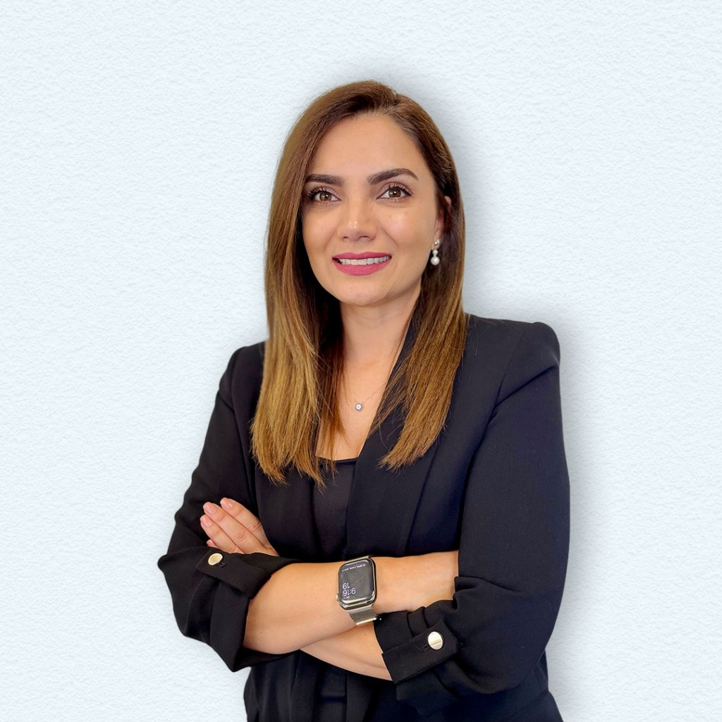 a woman with her arms crossed posing for a photo