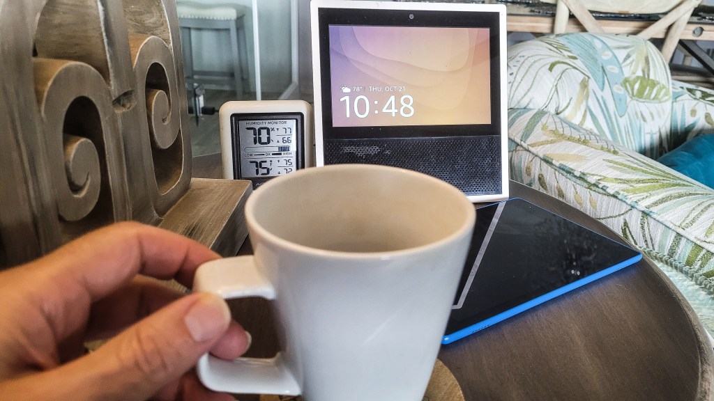 Assistive technology month 2023: a person holding a coffee cup in front of a laptop