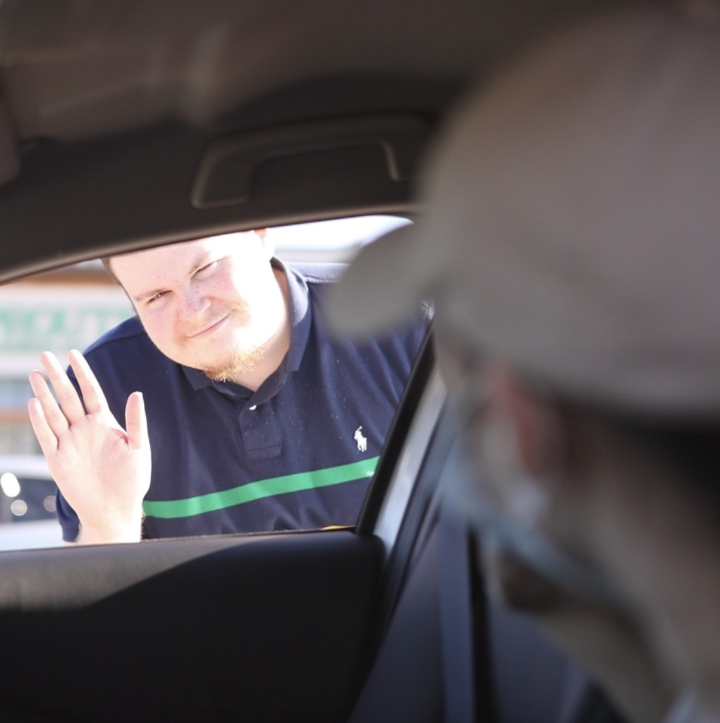 a man sitting in the passenger seat of a car
