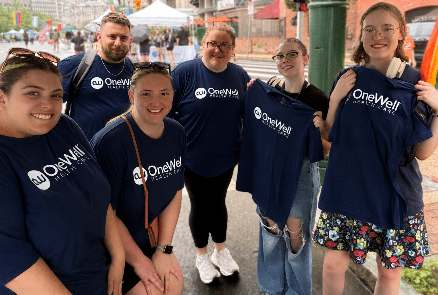 OneWell Health Care team smiling together at an outdoor community event — +5,000 professionals nationwide